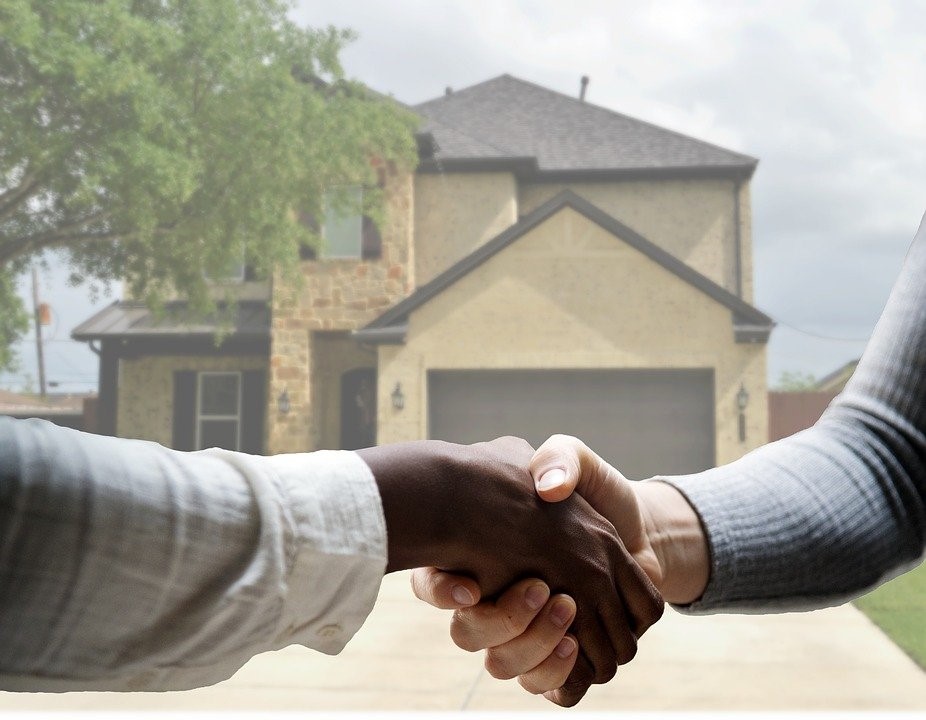 Home buyer and seller shaking hands