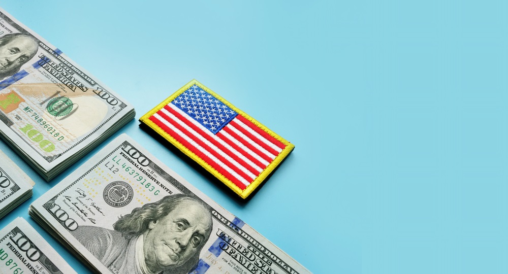 VA loan concept USA flag and stacks of cash